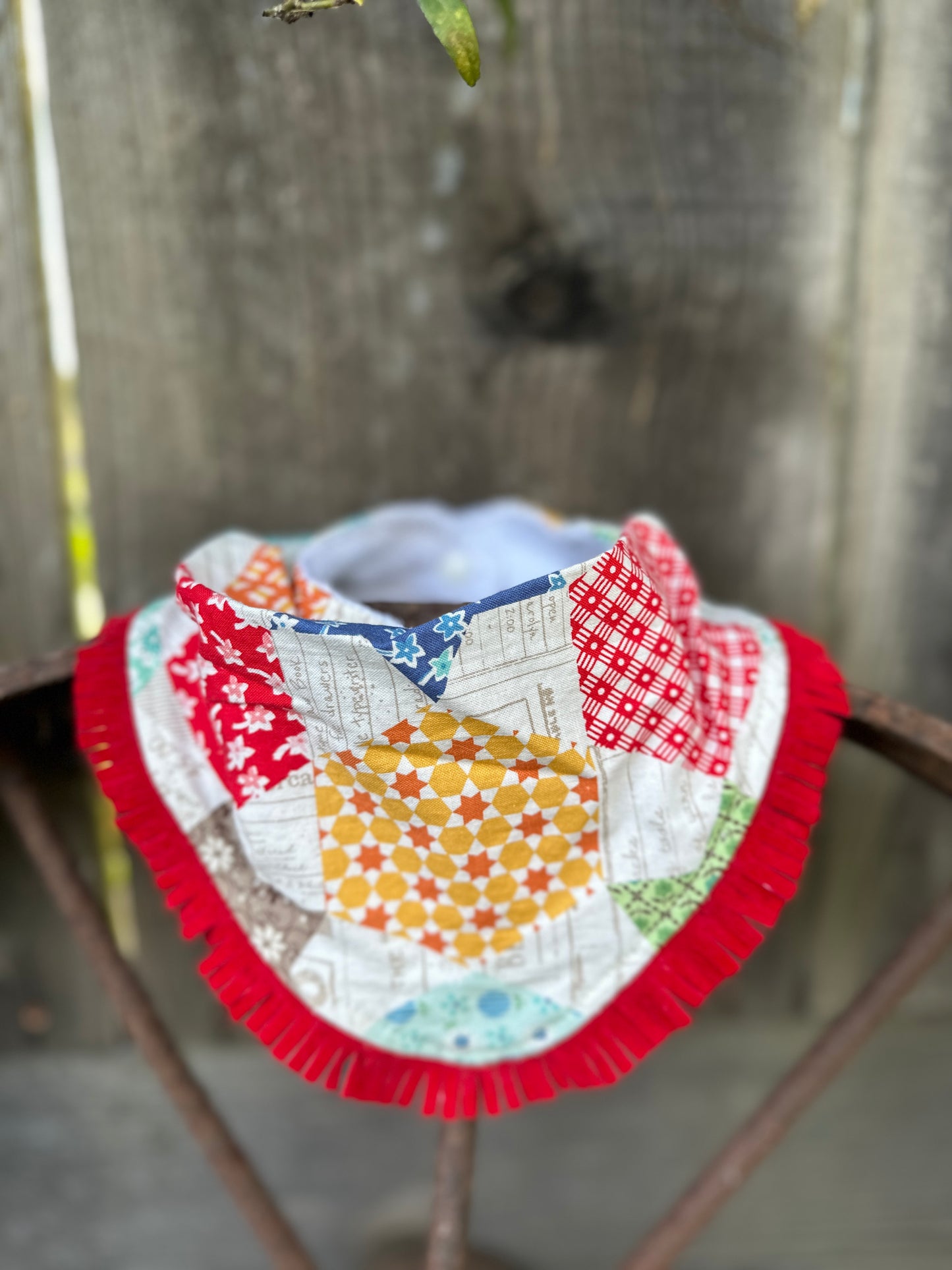 Colorful Quilt-Look Buckaroo Baby Bib with Red Fringe