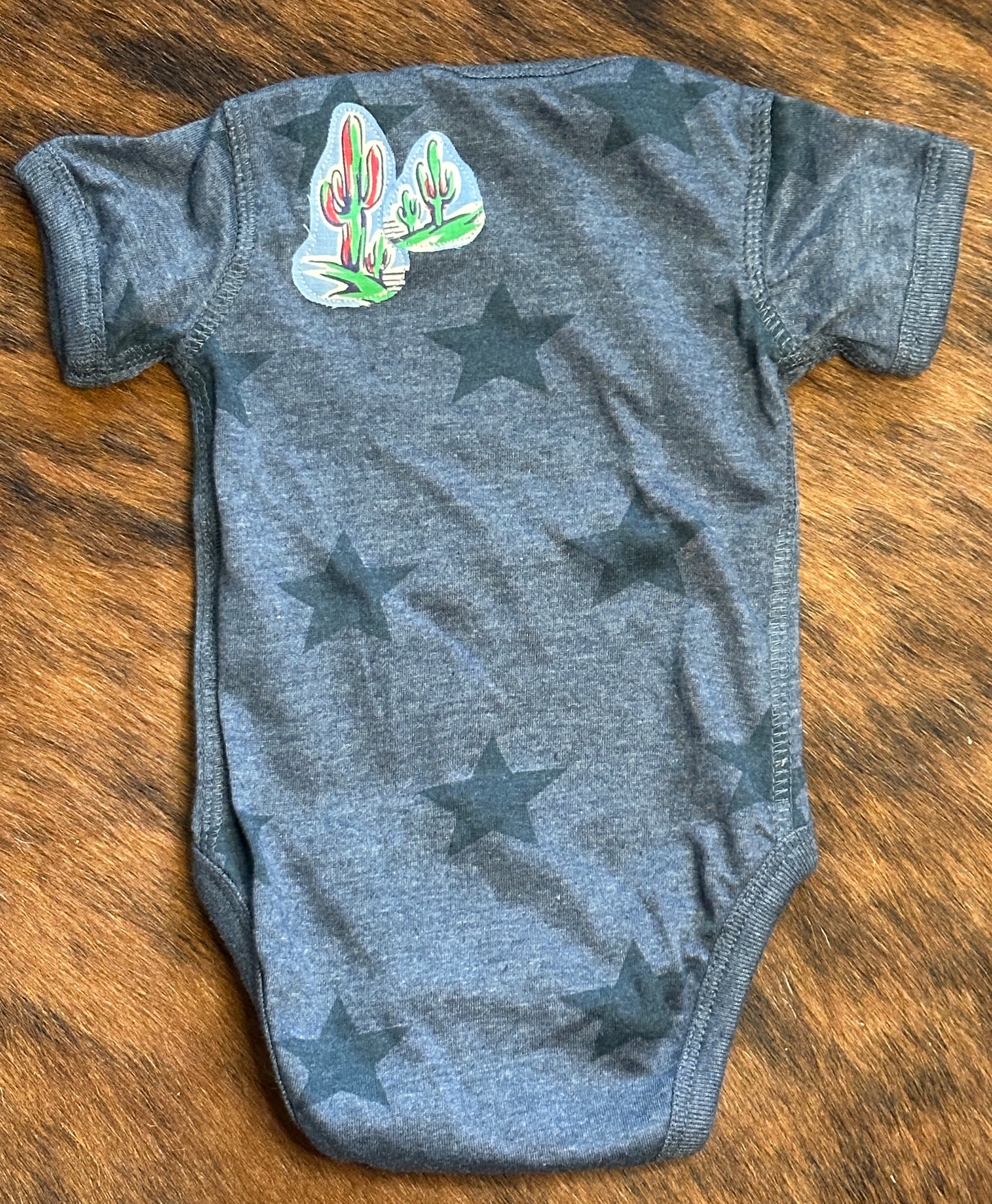Riding for a Fall Blue Heathered Star Onesie, Size Newborn