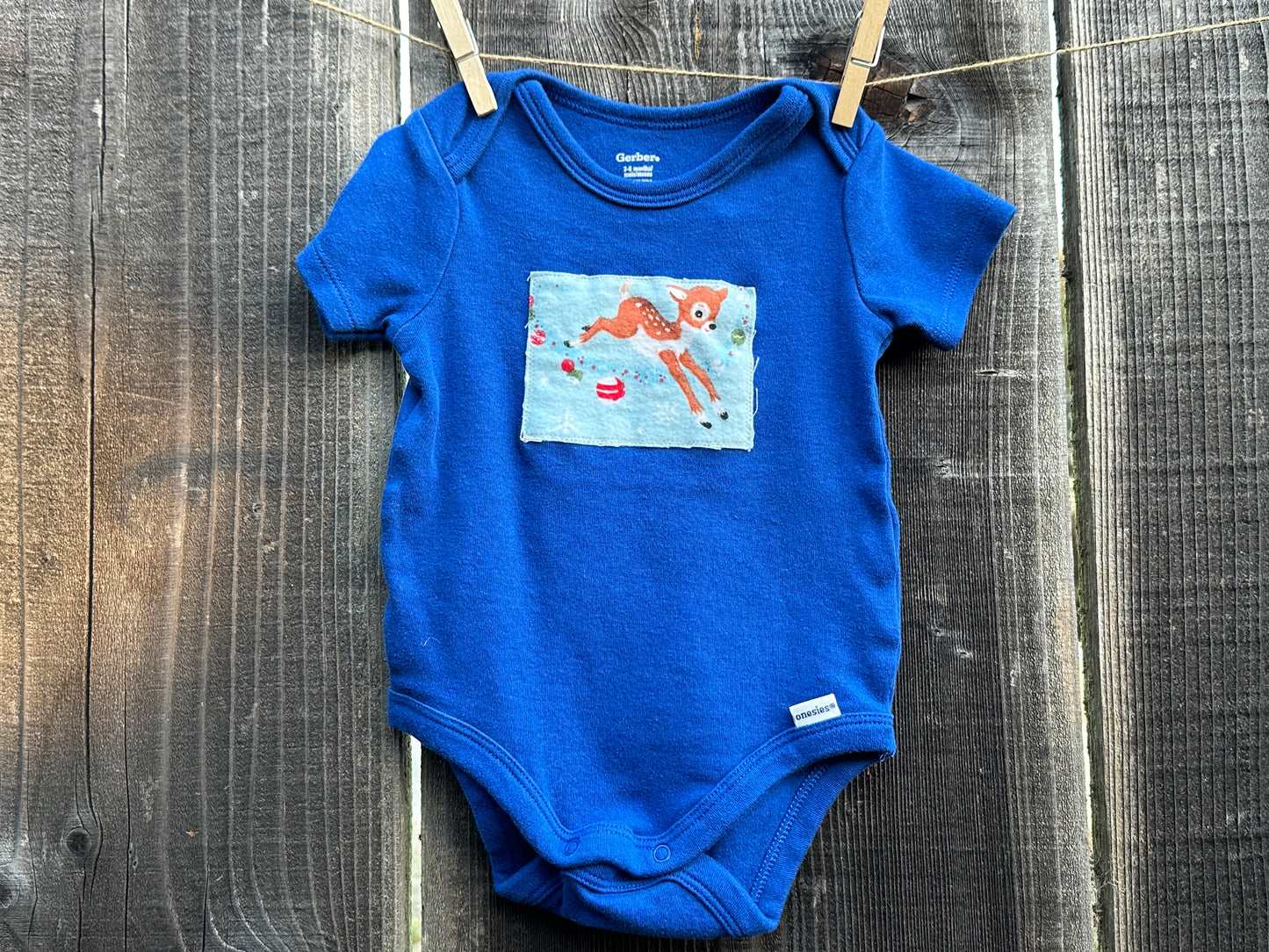 Reindeer Games Blue Onesie, Size 3-6 mons.