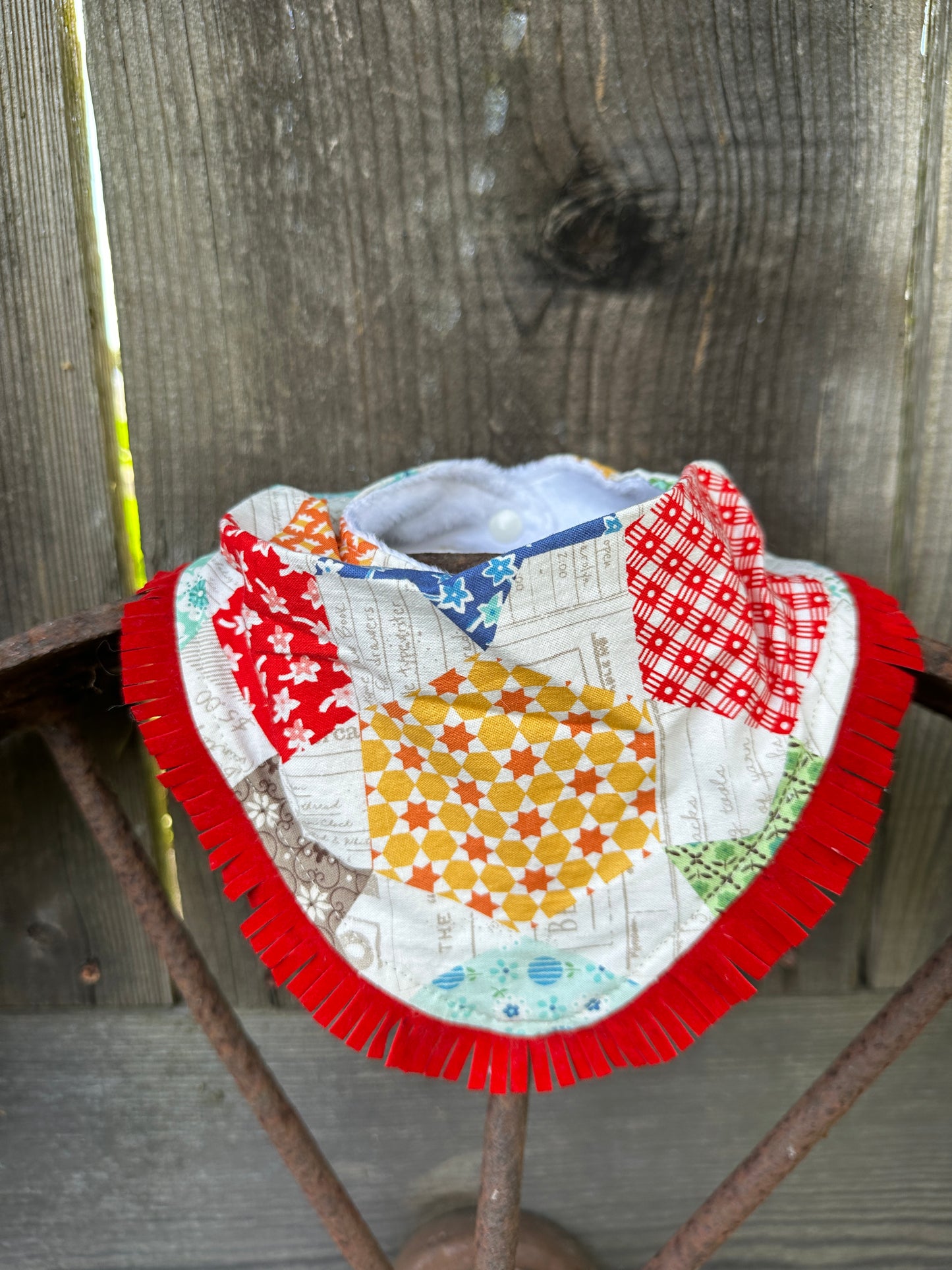Colorful Quilt-Look Buckaroo Baby Bib with Red Fringe