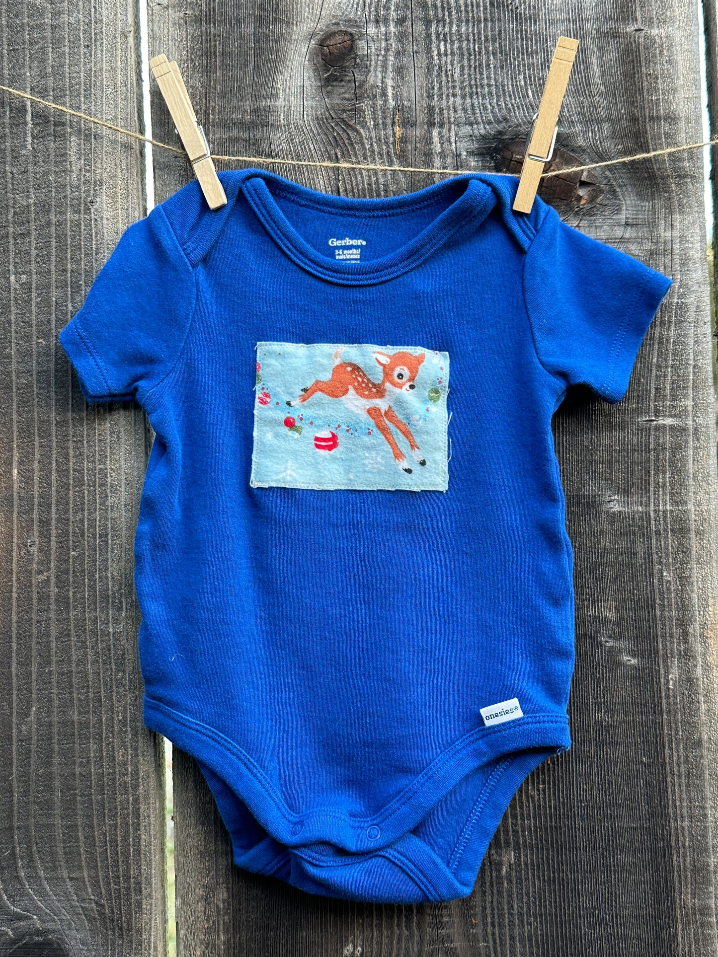 Reindeer Games Blue Onesie, Size 3-6 mons.