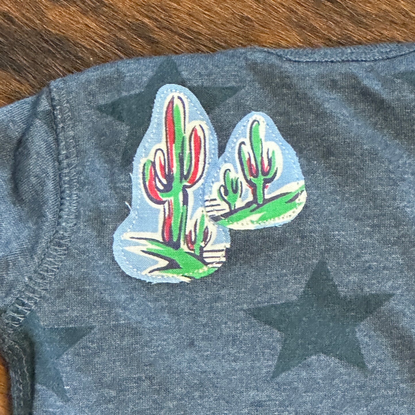 Riding for a Fall Blue Heathered Star Onesie, Size Newborn